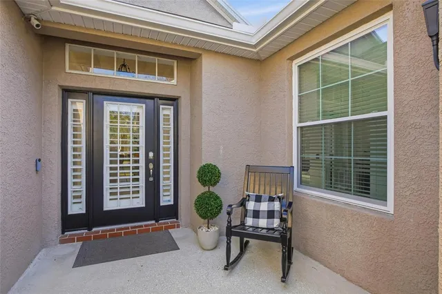 a living room with furniture a fireplace and a chandelier