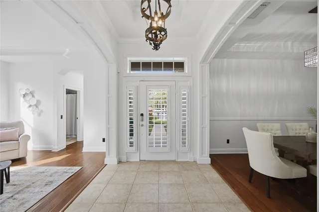 a living room with furniture and view of kitchen