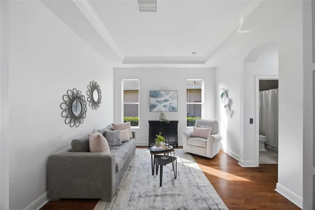 a view of a dining room with furniture a chandelier and wooden floor