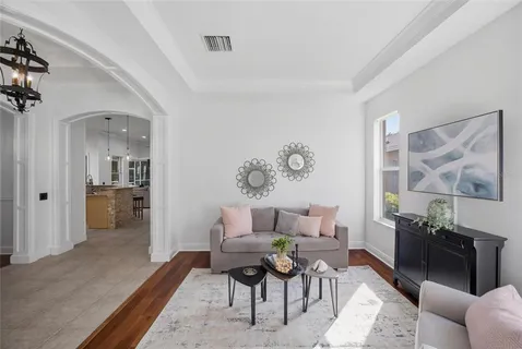 a living room with furniture fireplace and a chandelier