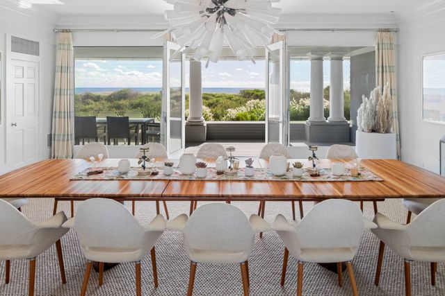 a view of a dining room with furniture wooden floor and chandelier