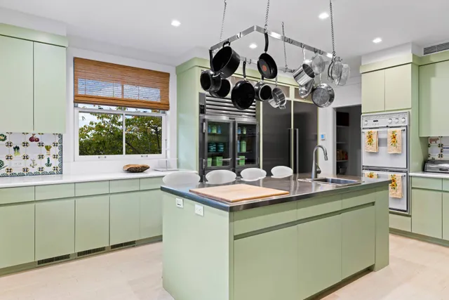 a kitchen view with stainless steel appliances granite countertop a sink and a large window