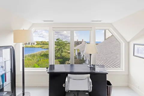 a view of a dining room with furniture and a window