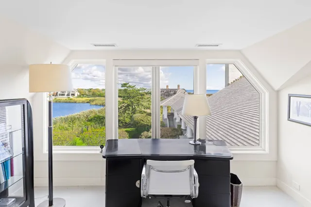 a view of a dining room with furniture and a window