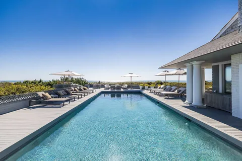 a swimming pool view with a outdoor seating space