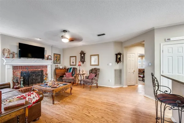 a living room with furniture fireplace and flat screen tv
