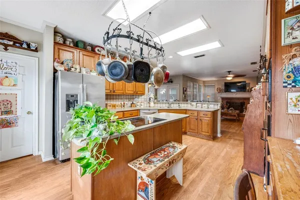 a kitchen with stainless steel appliances granite countertop a sink a counter space and cabinets