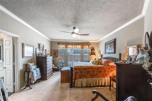 a bedroom with furniture and a large window