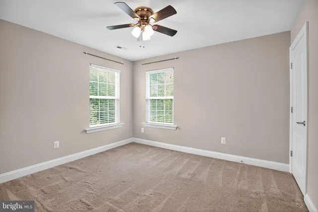 a view of a room with red walls and window