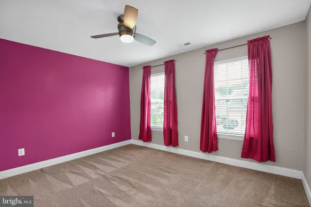 a bathroom with a granite countertop sink toilet mirror and bathtub