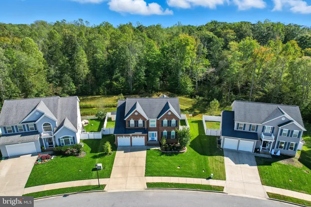 an aerial view of a house with a big yard