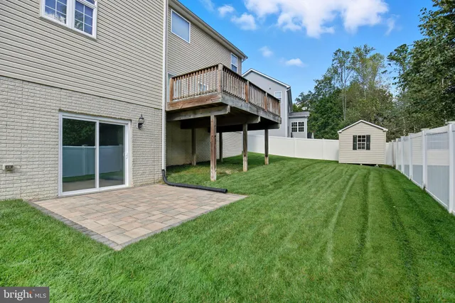 a front view of a house with a garden and yard