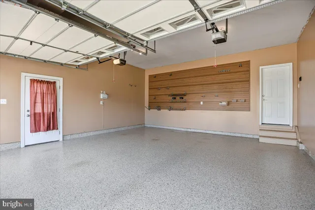 an aerial view of a house with backyard space and sitting area