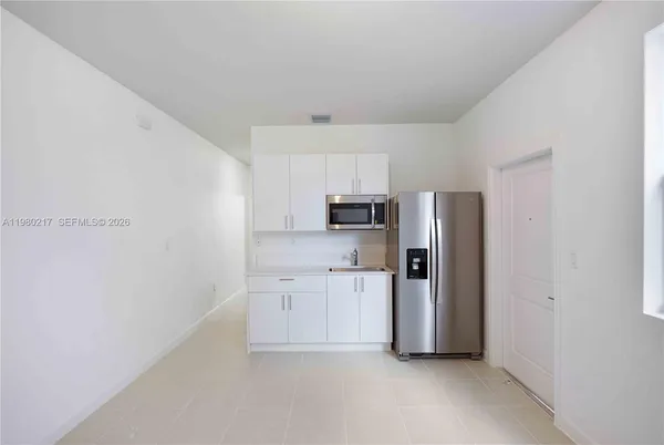 a kitchen with stainless steel appliances a refrigerator and a stove