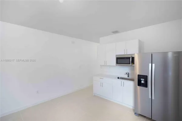 a kitchen with cabinets and stainless steel appliances