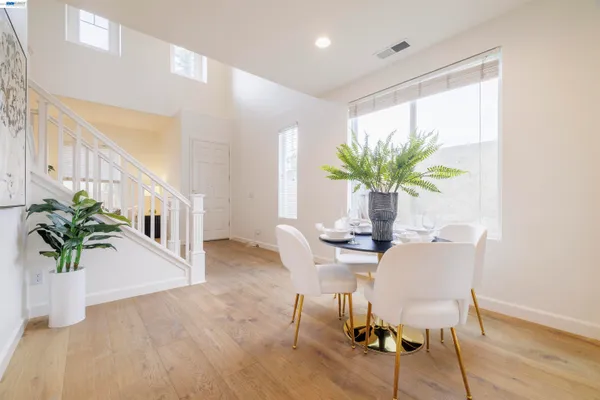a dining room with furniture and wooden floor