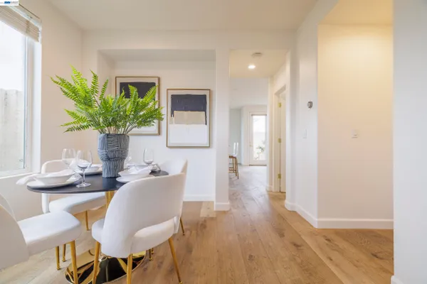 a dining room with furniture and a potted plant