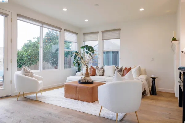 a living room with furniture kitchen and a table