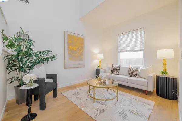 a living room with furniture a lamp and a window