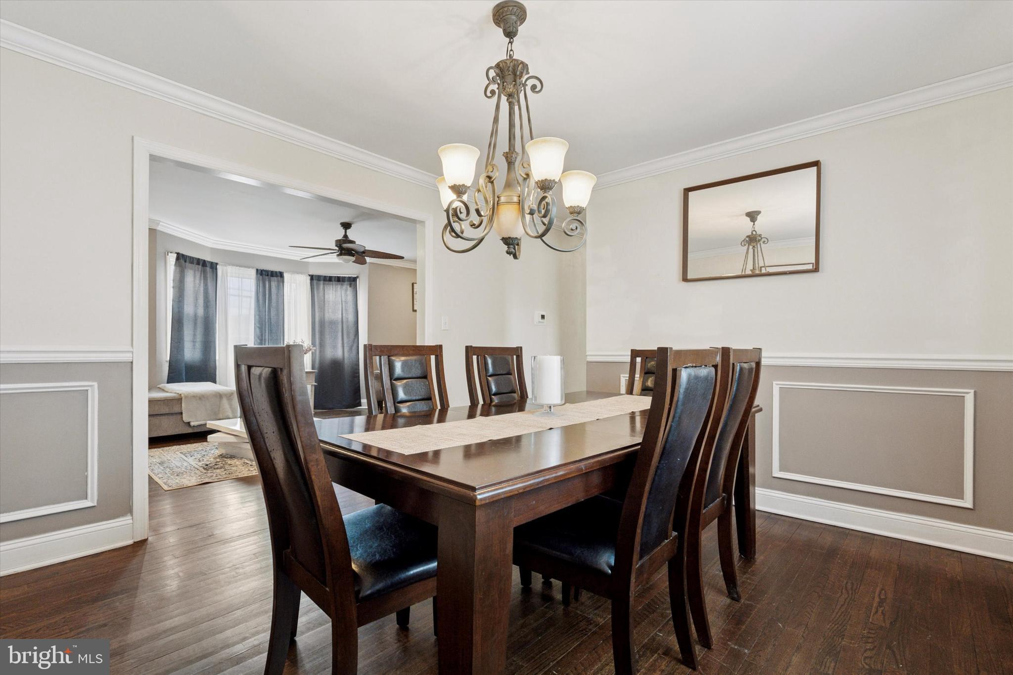 2310 Klockner Road Hamilton, NJ 08690 - Photo 12 of 33 a view of a dining room with furniture a chandelier and wooden floor