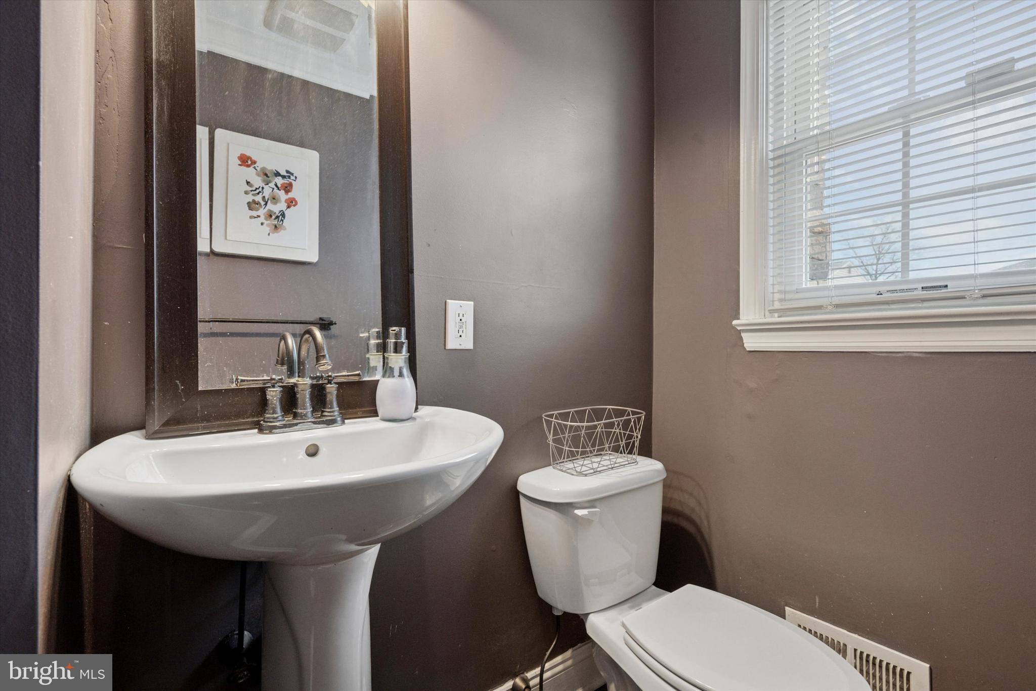 2310 Klockner Road Hamilton, NJ 08690 - Photo 15 of 33 a bathroom with a toilet a sink and a mirror