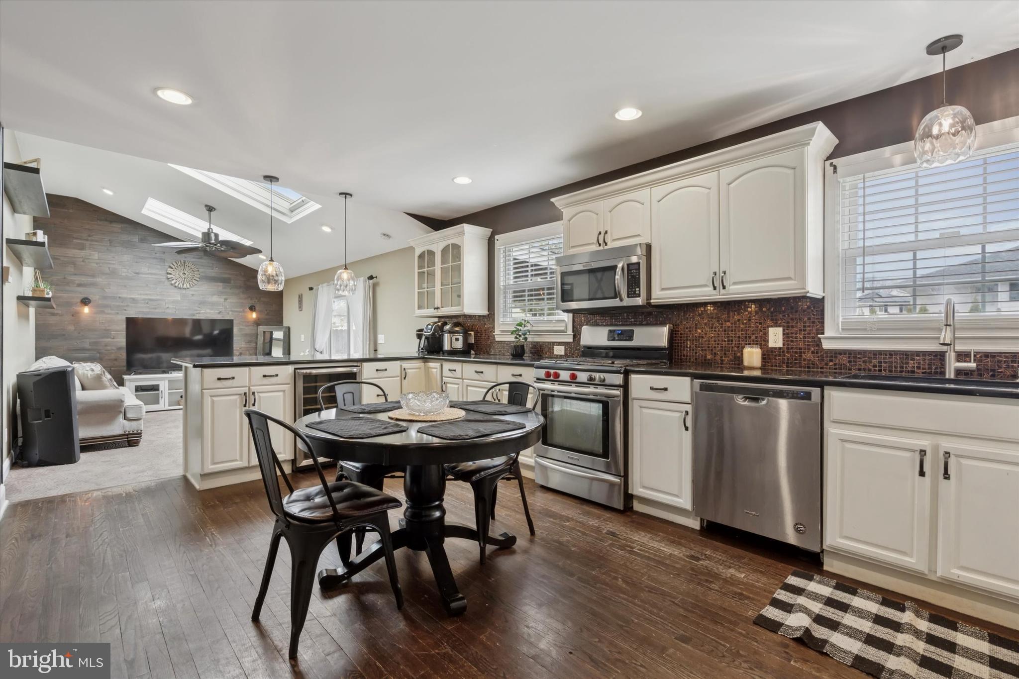 2310 Klockner Road Hamilton, NJ 08690 - Photo 16 of 33 a kitchen with stainless steel appliances granite countertop a table chairs sink refrigerator and cabinets
