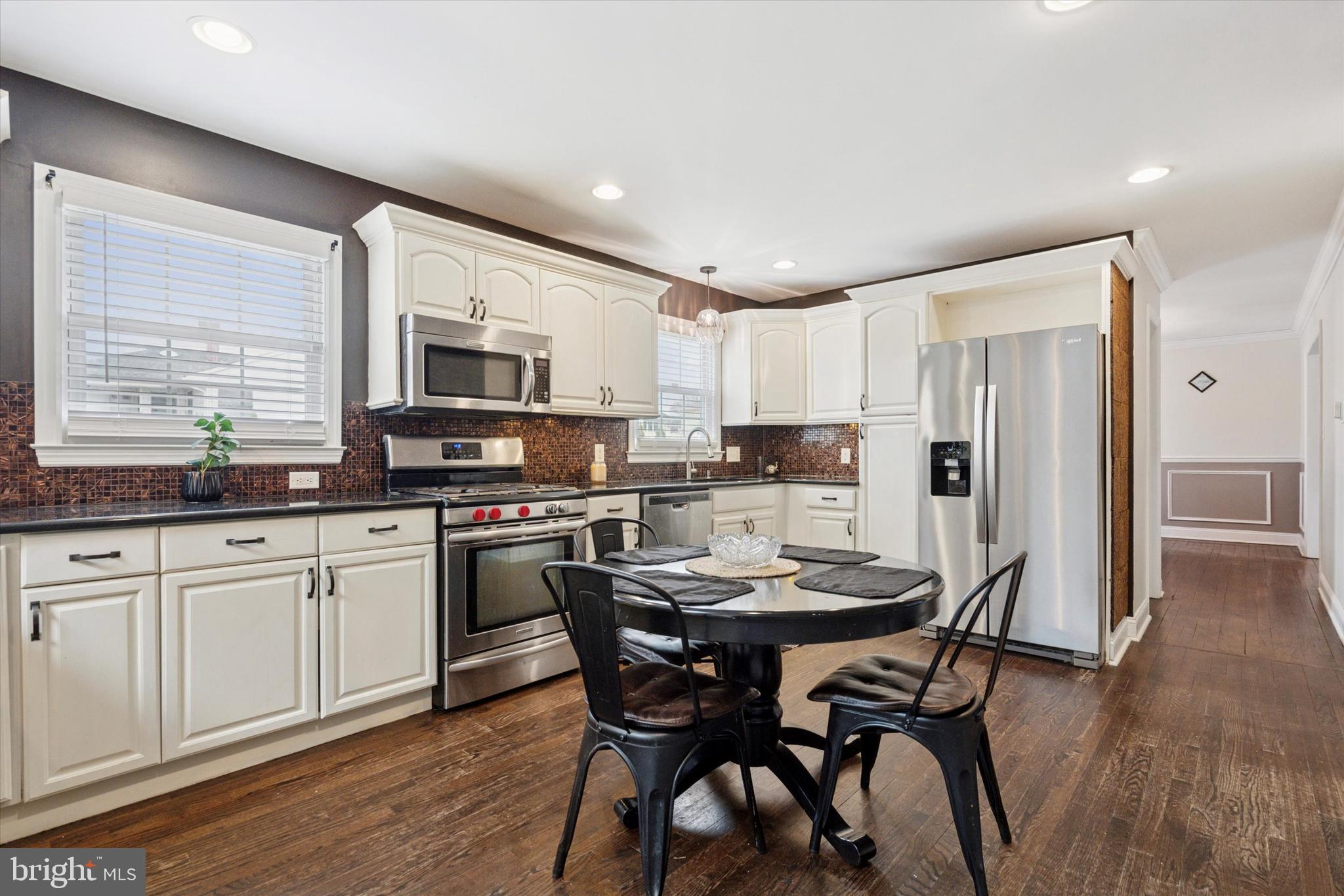 2310 Klockner Road Hamilton, NJ 08690 - Photo 18 of 33 a kitchen with a table chairs refrigerator and microwave