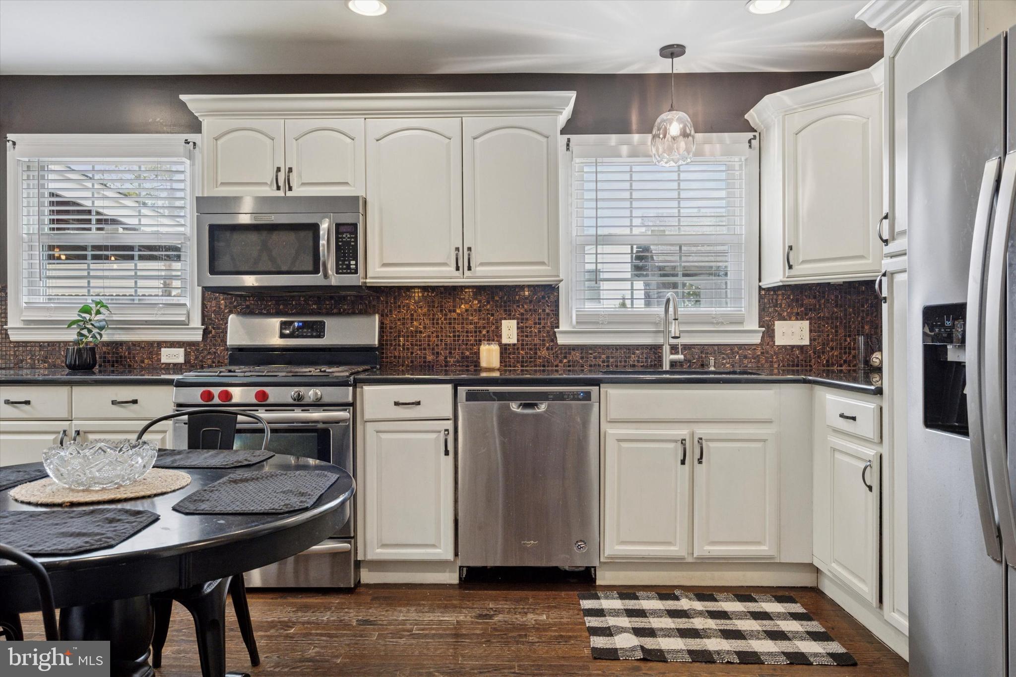 2310 Klockner Road Hamilton, NJ 08690 - Photo 20 of 33 a kitchen with stainless steel appliances granite countertop a stove a sink a microwave and cabinets