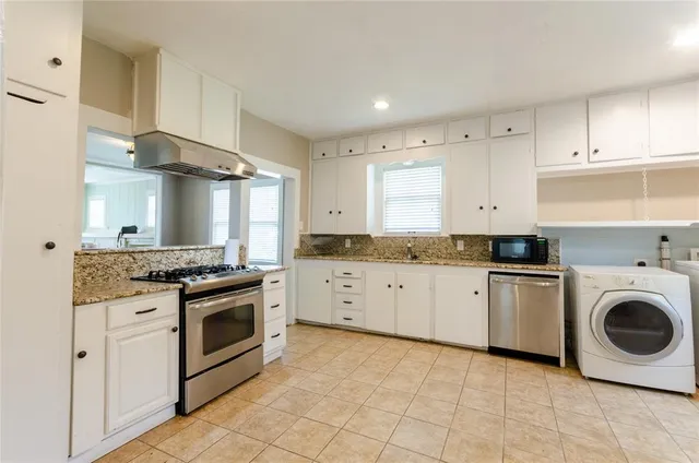 a kitchen with a stove top oven sink and cabinets