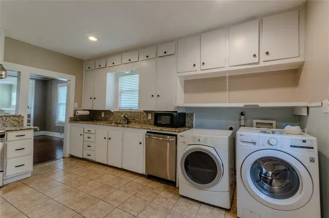a utility room with sink dryer and washer