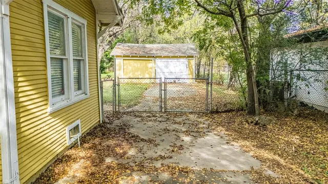 a view of a porch with a table and chairs