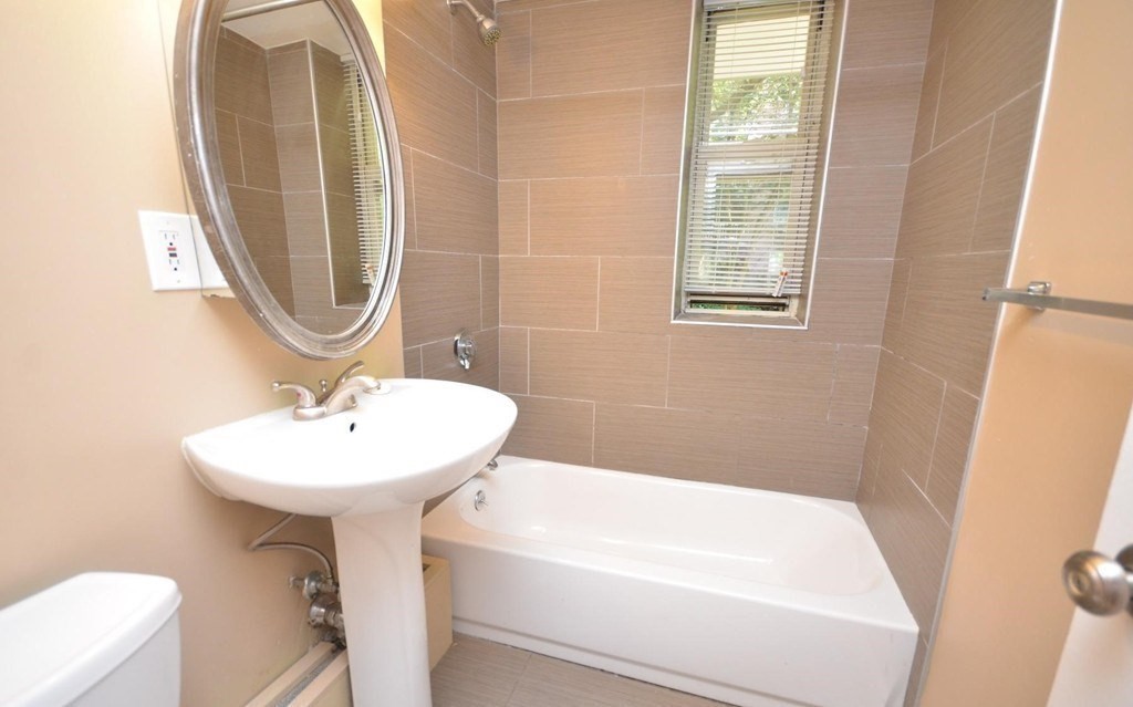 145 Pinckney Street, Unit 135 Boston, MA 02114 - Photo 6 of 7 a bathroom with a sink a toilet and a bathtub