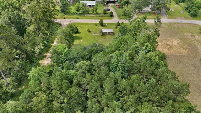 an aerial view of a houses with yard