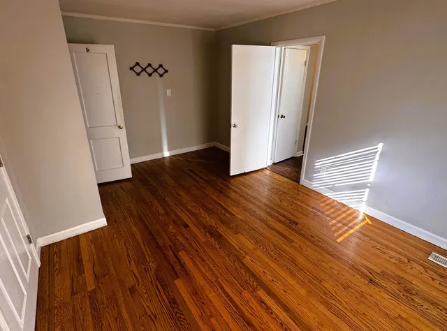 a view of a livingroom with wooden floor and a ceiling fan