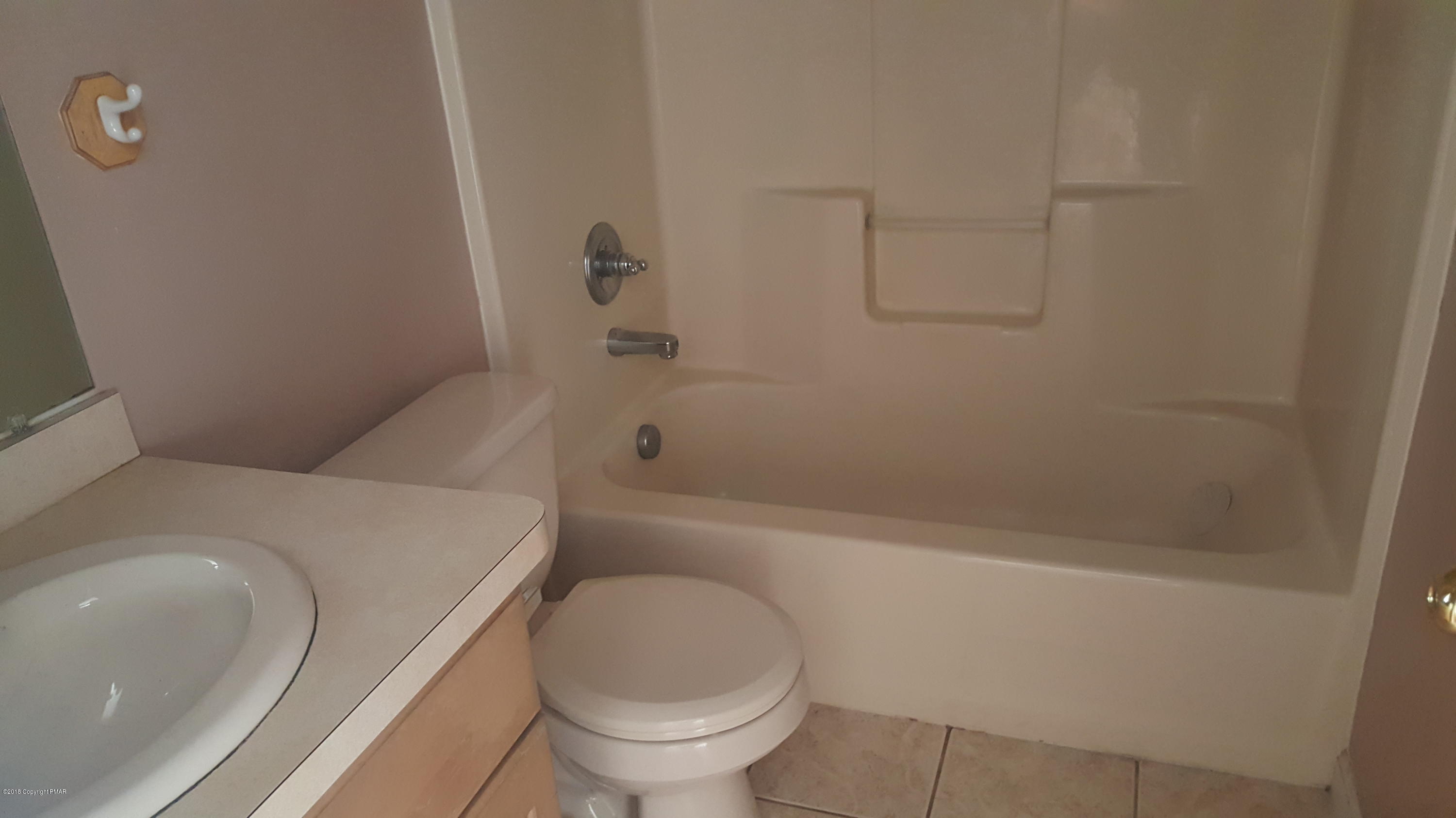 1485 Clover Road Long Pond, PA 18334 - Photo 12 of 23 a white toilet sitting next to a bath tub