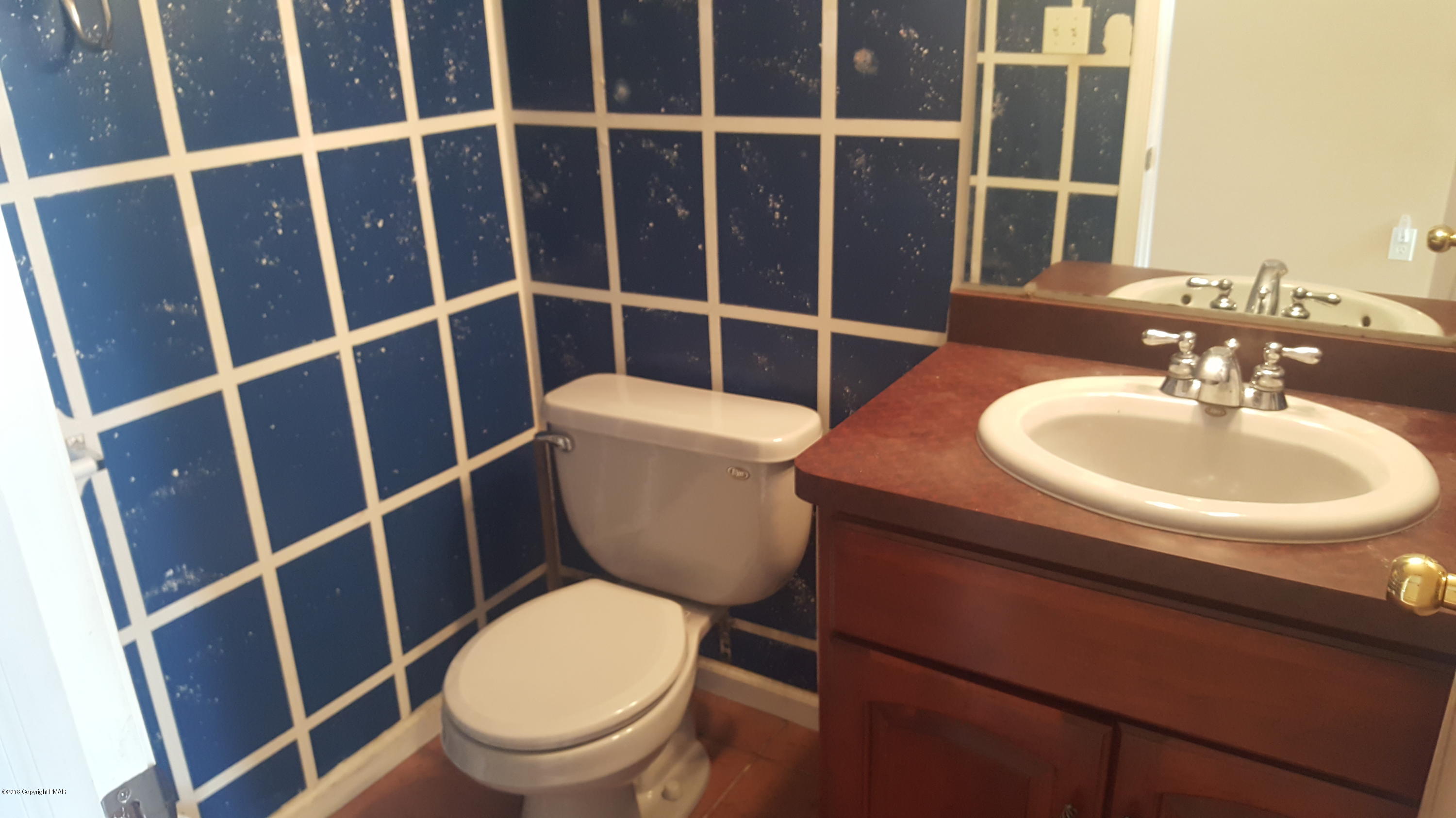1485 Clover Road Long Pond, PA 18334 - Photo 15 of 23 a bathroom with a toilet a sink and a mirror