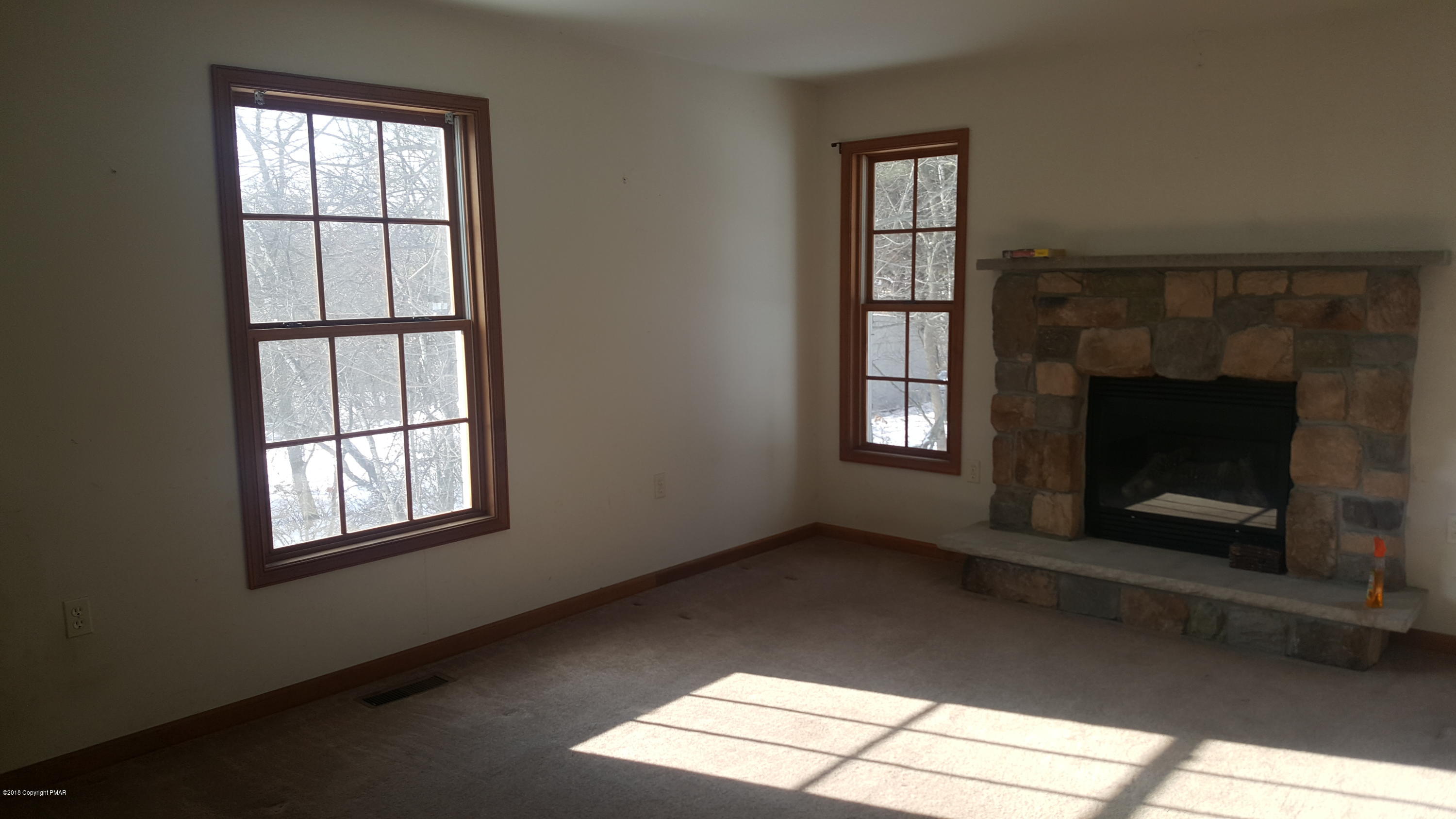 1485 Clover Road Long Pond, PA 18334 - Photo 7 of 23 an empty room with windows and fireplace