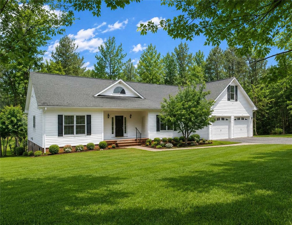A well-maintained lawn welcomes you to this classic residence, nestled among vibrant greenery.