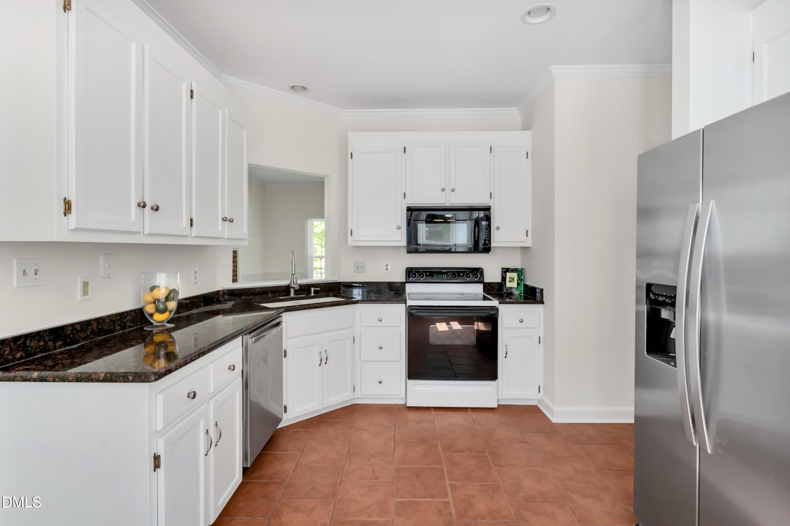 7500 Drayton Court Raleigh, NC 27615 - Photo 7 of 27 a kitchen with white cabinets and stainless steel appliances