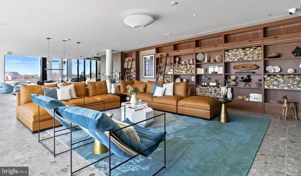 a living room with furniture a rug and a large window