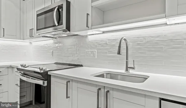 a kitchen with stainless steel appliances a refrigerator and a stove top oven