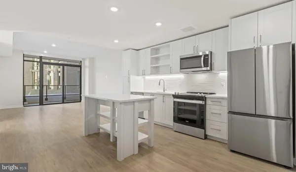 a kitchen with a sink a refrigerator a washer and dryer