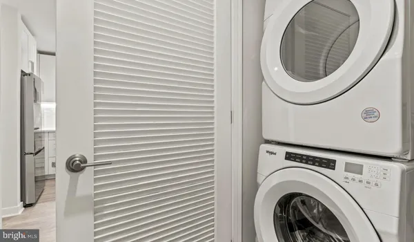 a kitchen with stainless steel appliances a microwave a sink and cabinets