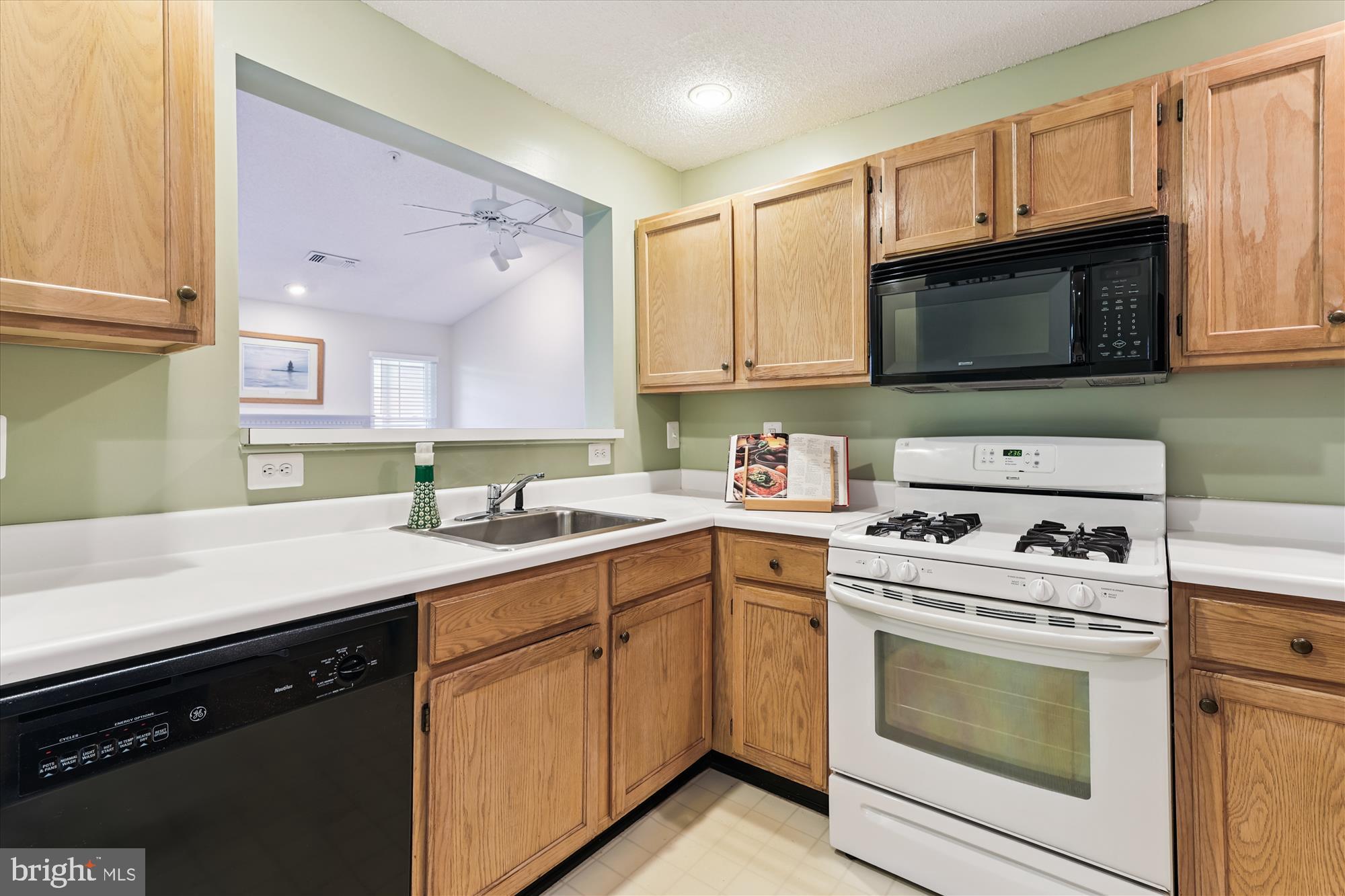 12005 Taliesin Place, Unit 35 Reston, VA 20190 - Photo 11 of 39 a kitchen with a sink stove and microwave
