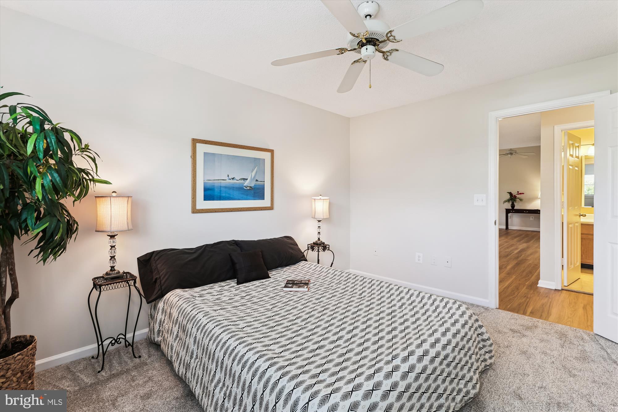 12005 Taliesin Place, Unit 35 Reston, VA 20190 - Photo 16 of 39 a bedroom with a bed lamp and a potted plant