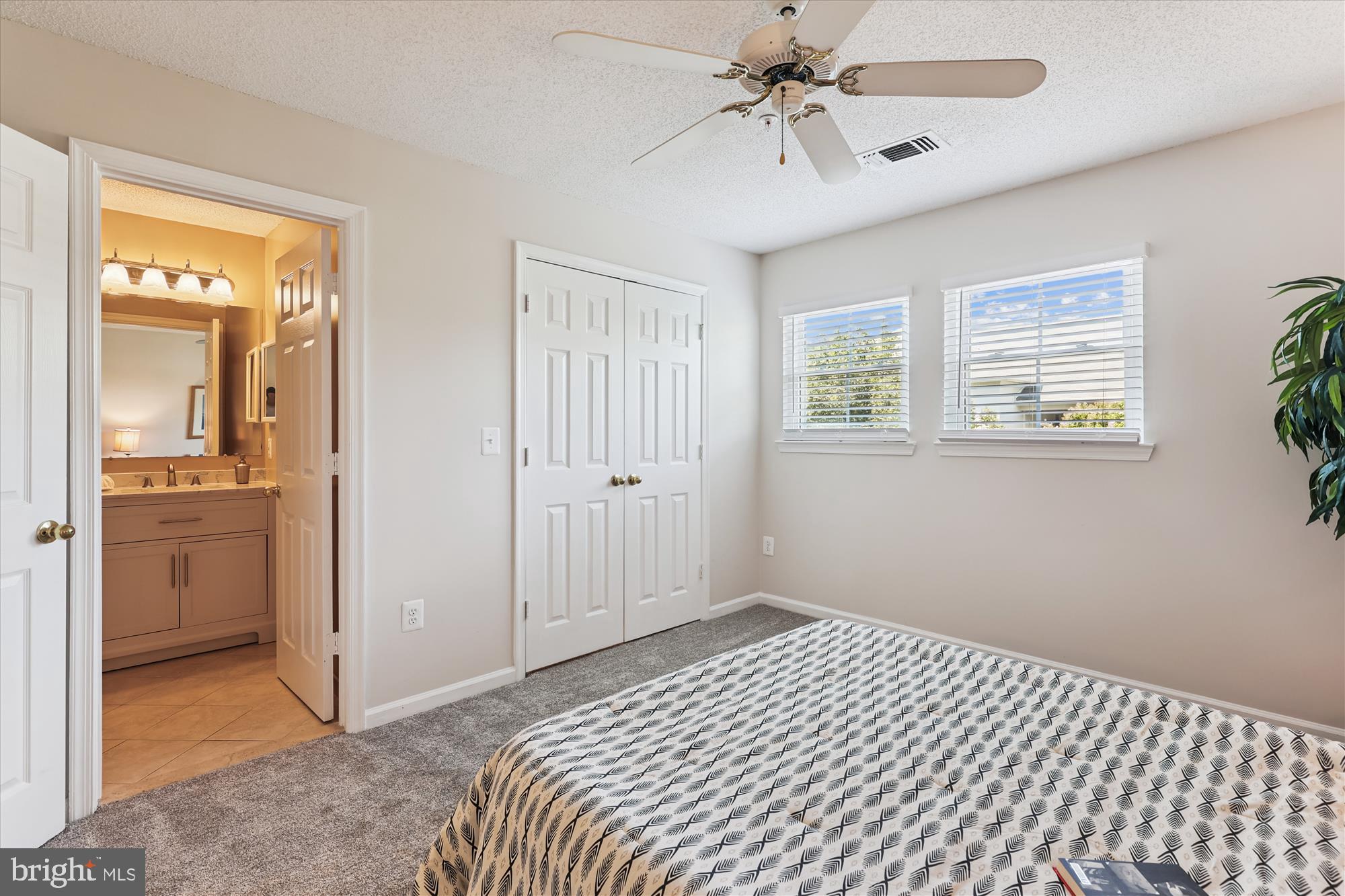 12005 Taliesin Place, Unit 35 Reston, VA 20190 - Photo 17 of 39 a bedroom with a bed and a chandelier fan