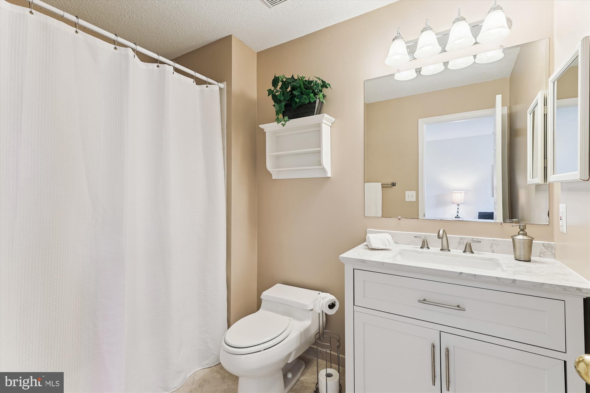 12005 Taliesin Place, Unit 35 Reston, VA 20190 - Photo 18 of 39 a bathroom with a sink vanity mirror and toilet