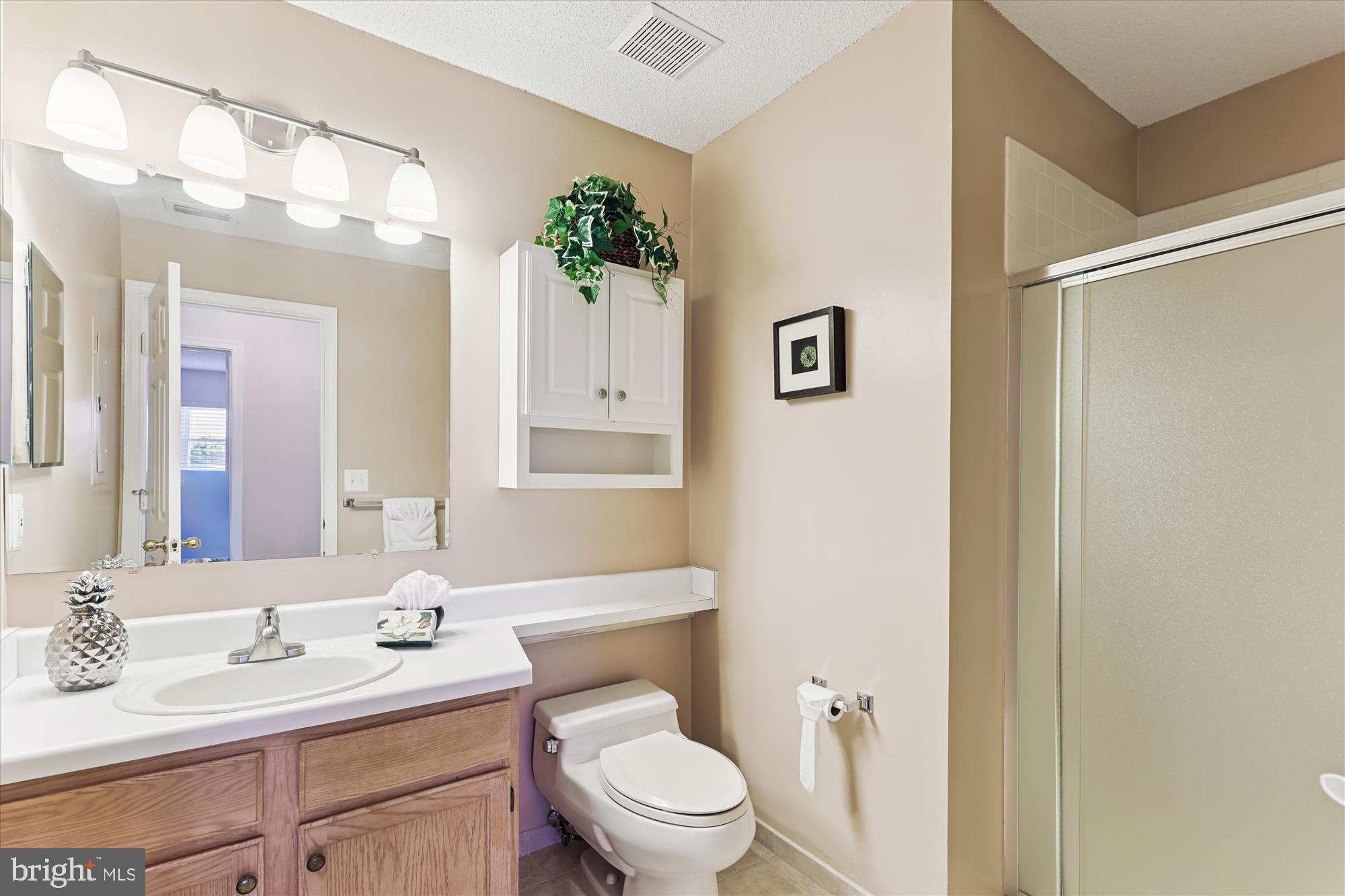 12005 Taliesin Place, Unit 35 Reston, VA 20190 - Photo 21 of 39 a bathroom with a toilet a sink and a mirror