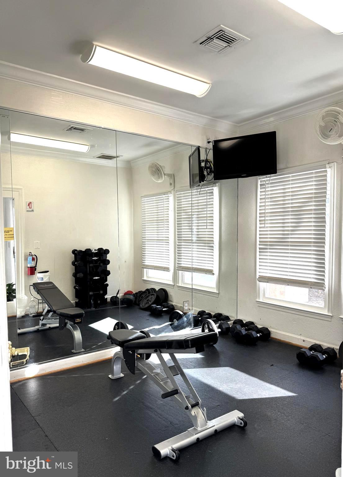 12005 Taliesin Place, Unit 35 Reston, VA 20190 - Photo 26 of 39 a room with gym equipment and a large window