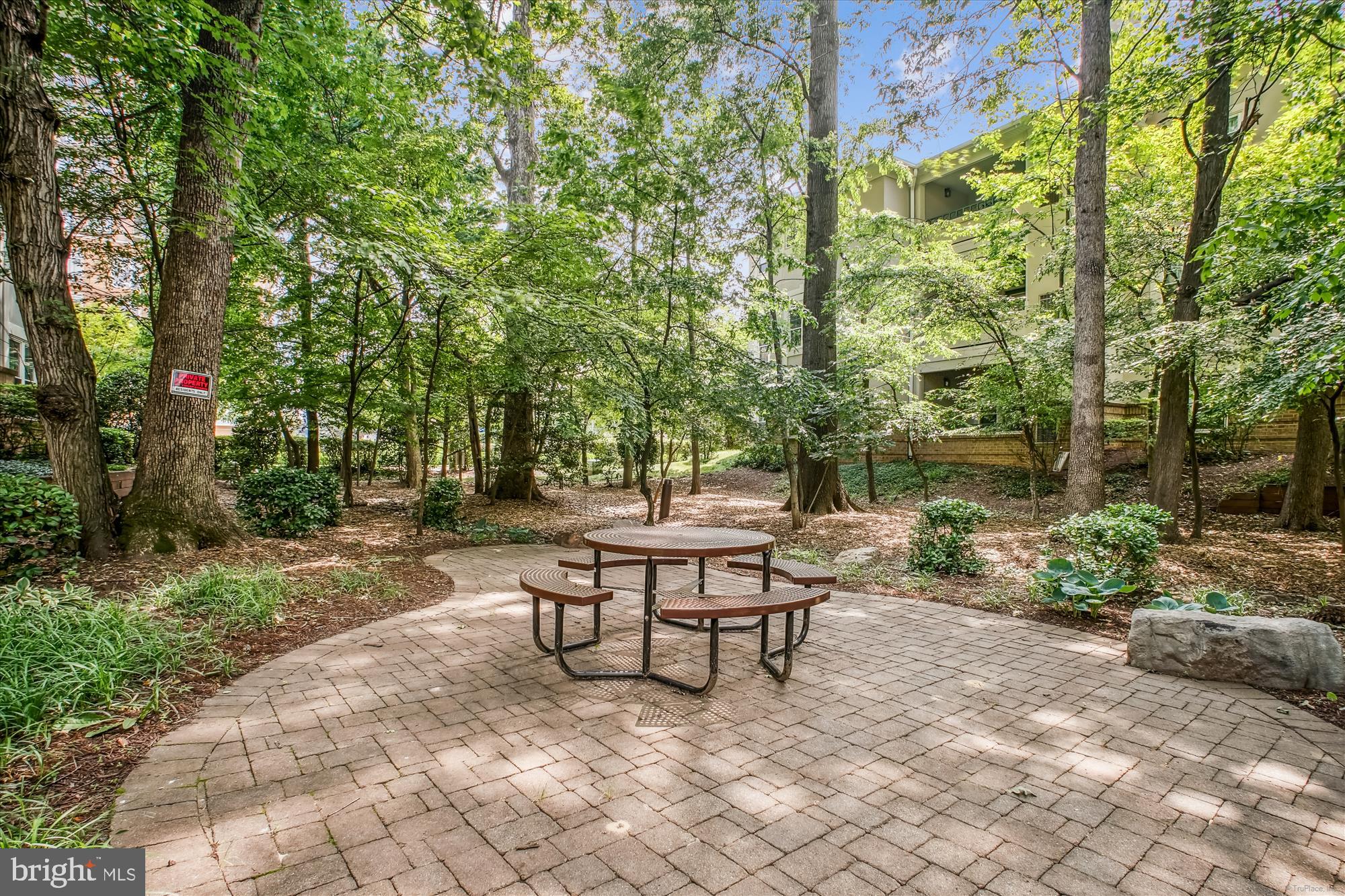 12005 Taliesin Place, Unit 35 Reston, VA 20190 - Photo 29 of 39 a swimming pool with outdoor seating and trees
